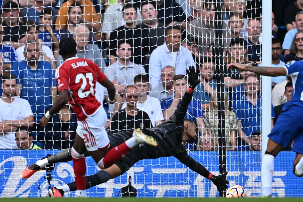 Nottingham Forest's Swedish midfielder #21 Anthony Elanga scores the opening goal past Chelsea's Spanish goalkeeper #01 Robert Sanchez during the English Premier League football match between Chelsea and Nottingham Forest at Stamford Bridge in London on September 2, 2023. (Photo by JUSTIN TALLIS / AFP)