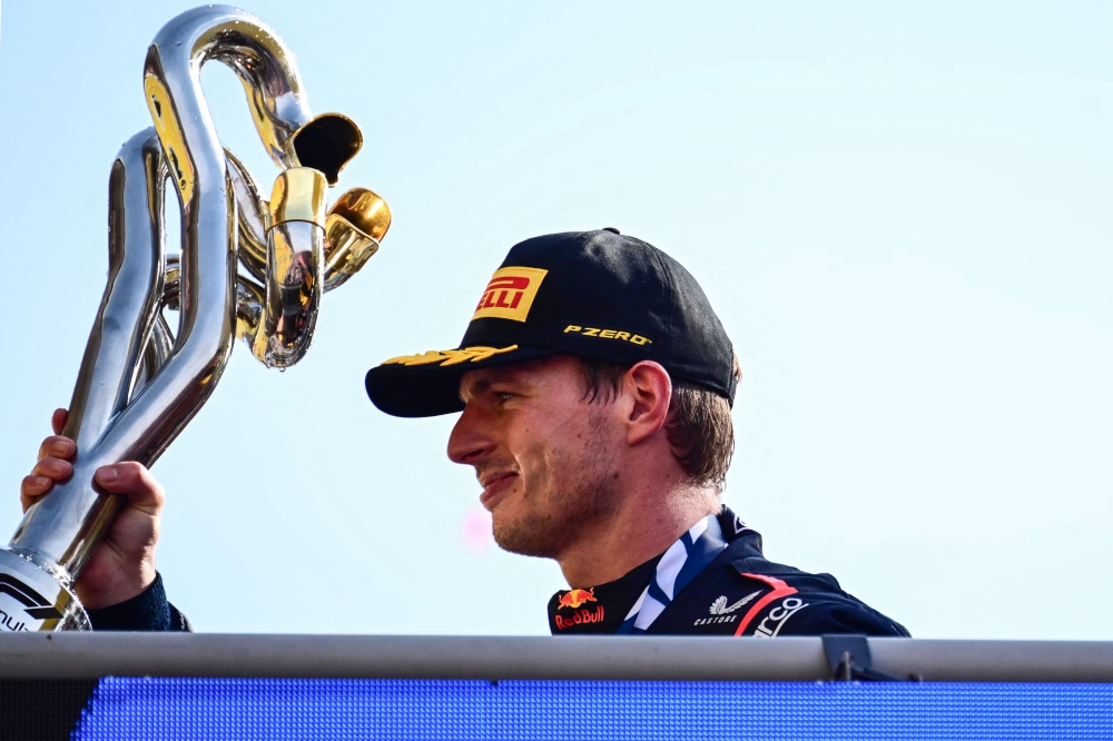 First placed Red Bull Racing's Dutch driver Max Verstappen celebrates with his trophy on the podium after the Italian Formula One Grand Prix race at Autodromo Nazionale Monza circuit, in Monza on September 3, 2023. (Photo by Ben Stansall / AFP)