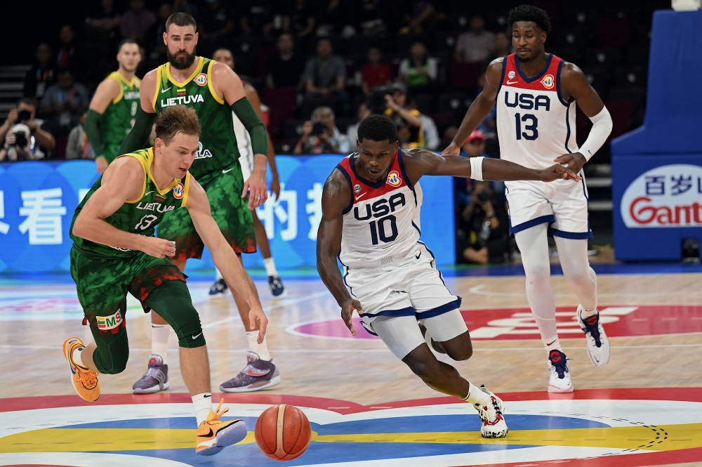 :Lithuania's Rokas Jokubaitis (L) and USA's Anthony Edwards (R) compete for the ball during the FIBA Basketball World Cup second round match between USA and Lithuania at Mall of Asia Arena in Pasay City, suburban Manila on September 3, 2023. (Photo by JAM STA ROSA / AFP)
