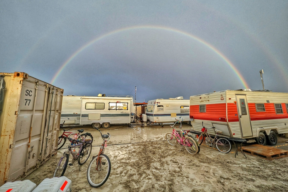This handout image provided courtesy of Josh Lease on September 3, 2023 shows a double rainbow over flooding on a desert plain on September 1, 2023, after heavy rains turned the annual Burning Man festival site in Nevada's Black Rock desert into a mud pit. (Photo by Josh Lease / UGC / AFP) 