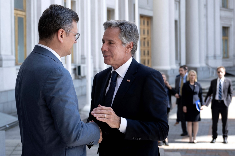 Ukraine's Foreign Minister Dmytro Kuleba greets US Secretary of State Antony Blinken before a meeting at the Ministry of Foreign Affairs in Kyiv on September 6, 2023. (Photo by Brendan Smialowski / Pool/ AFP)