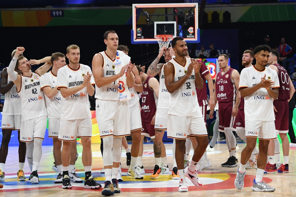 German players celebrate their victory in the FIBA Basketball World Cup quarter-final match between Germany and Latvia at the Mall of Asia Arena in Manila on September 6, 2023. (Photo by Ted ALJIBE / AFP)
