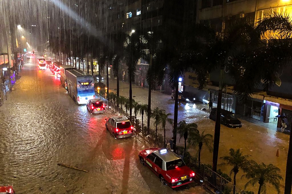 A general view of a flooded street after heavy rainstorms triggered a 'Black Rainstorm Warning' from the city's weather observatory, in Hong Kong on September 7, 2023. (Photo by Matt Surrusco / AFP)