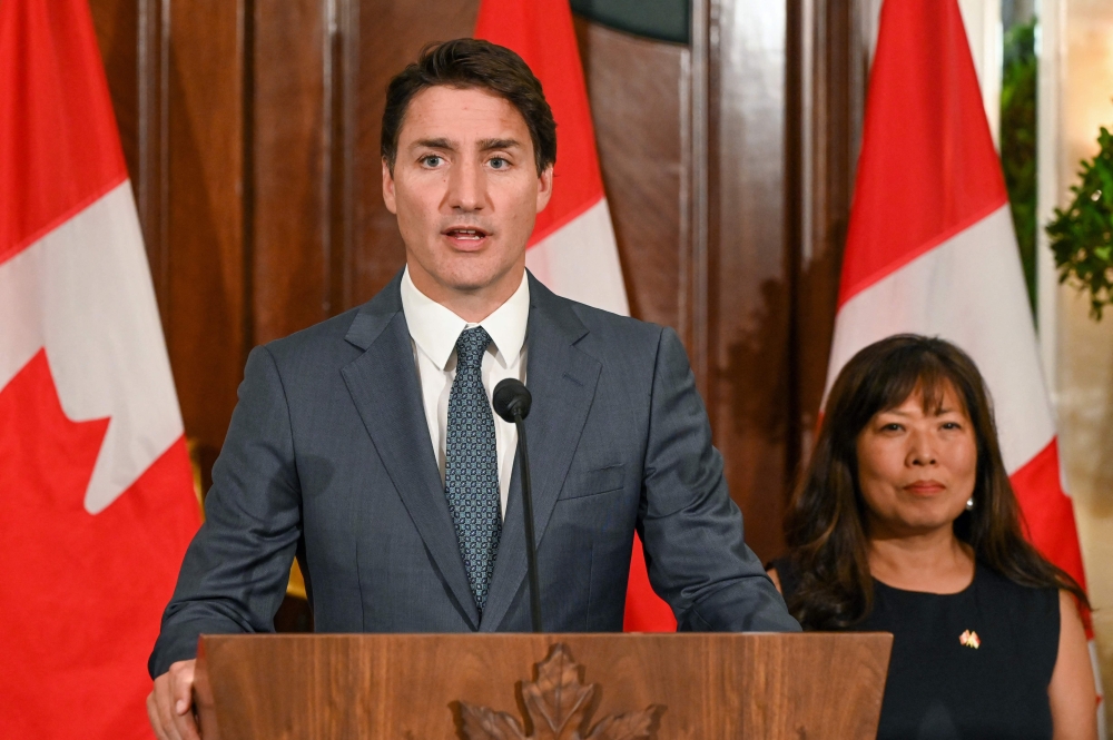 Canada's Prime Minister Justin Trudeau speaks next to his International Trade Minister Mary Ng at a press conference during a stopover visit to Singapore on September 8, 2023. (Photo by Roslan Rahman / AFP)