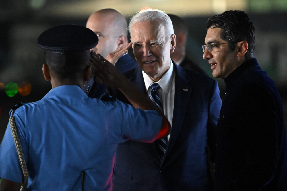 US President Joe Biden is greeted upon his arrival at the airport on the eve of the two-day G20 summit in New Delhi on September 8, 2023. (Photo by Saul Loeb / AFP)


