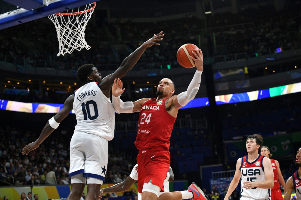 Canada's Dillon Brooks (R) lays up against USA's Anthony Edwards during the FIBA Basketball World Cup game for third place between USA and Canada in Manila on September 10, 2023. Photo by Ted ALJIBE / AFP