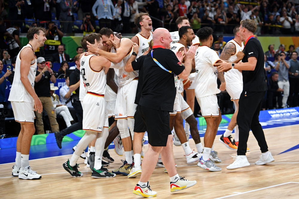 Germany's team celebrates after winning the FIBA Basketball World Cup final game against Serbia in Manila on September 10, 2023. (Photo by Ted Aljibe / AFP)