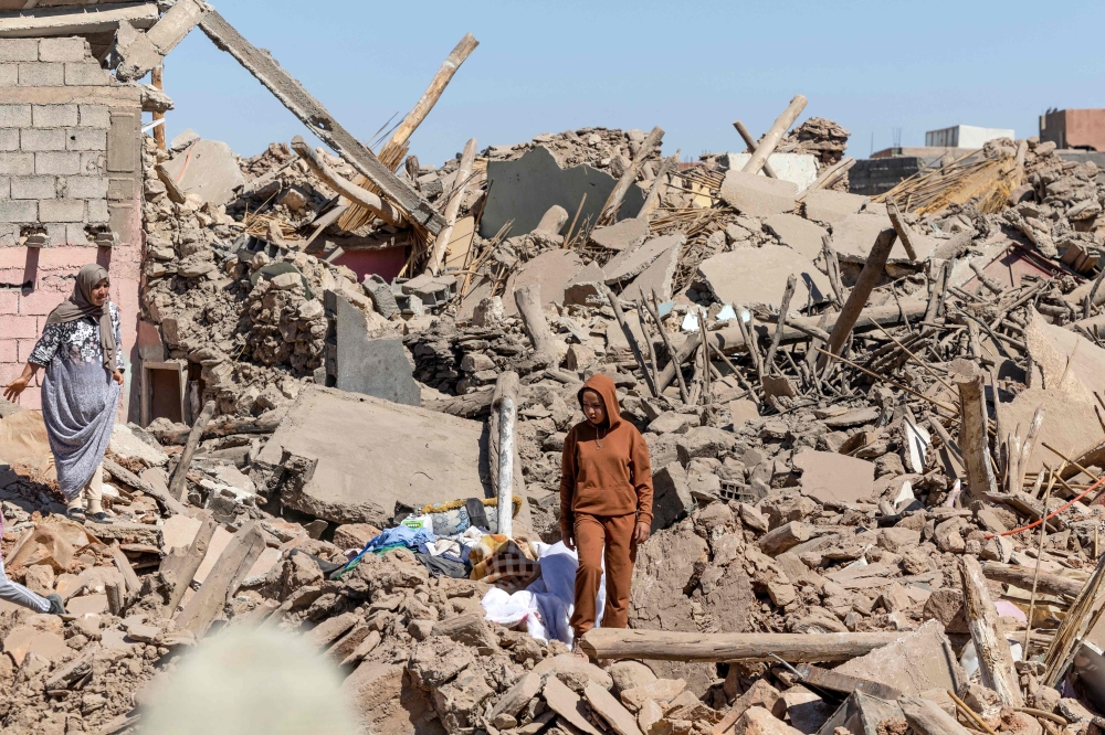 Villagers inspect the rubble of collapsed houses in Tafeghaghte on September 10, 2023. (Photo by Fadel Senna / AFP)
