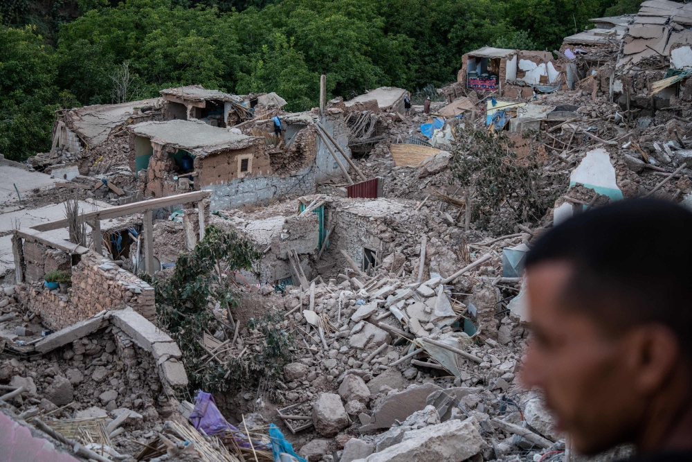 A man looks at the rubble of homes in the mountain village of Imi N'Tala, south of Marrakech, on September 10, 2023.  (Photo by Matias Chiofalo / AFP)
