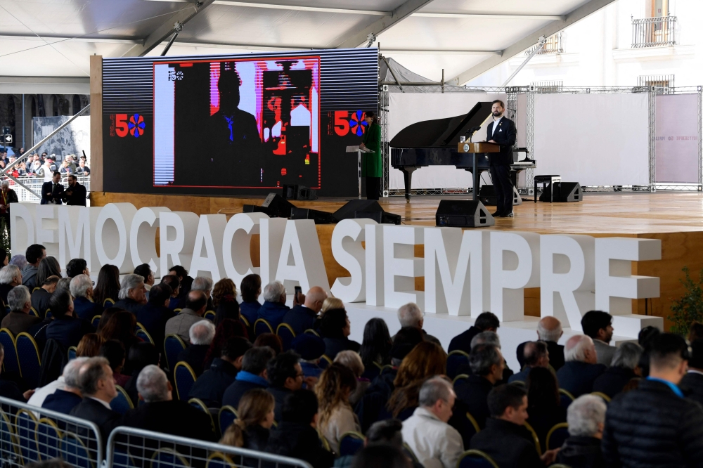 Chile's President Gabriel Boric speaks during a ceremony to commemorate the 50th anniversary of the Chilean dictatorship in front of La Moneda Presidential Palace in Santiago, on September 11, 2023.  (Photo by Javier Torres / AFP)
