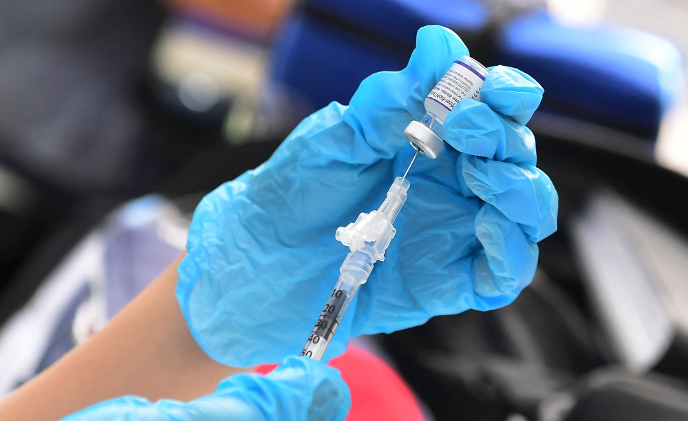 The Pfizer Covid-19 vaccine is prepared for administration at a vaccination clinic for homeless people, hosted by the Los Angeles County Department of Public Health and United Way on September 22, 2021 in Los Angeles, California. (Photo by Frederic J. Brown / AFP)
