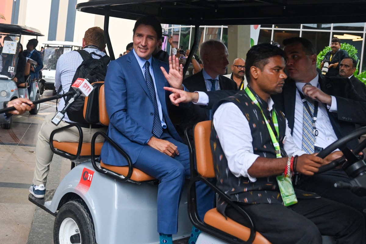 Canada's Prime Minister Justin Trudeau (C) arrives to attend a press conference after the closing session of the G20 summit in New Delhi on September 10, 2023. (Photo by Money Sharma / AFP)