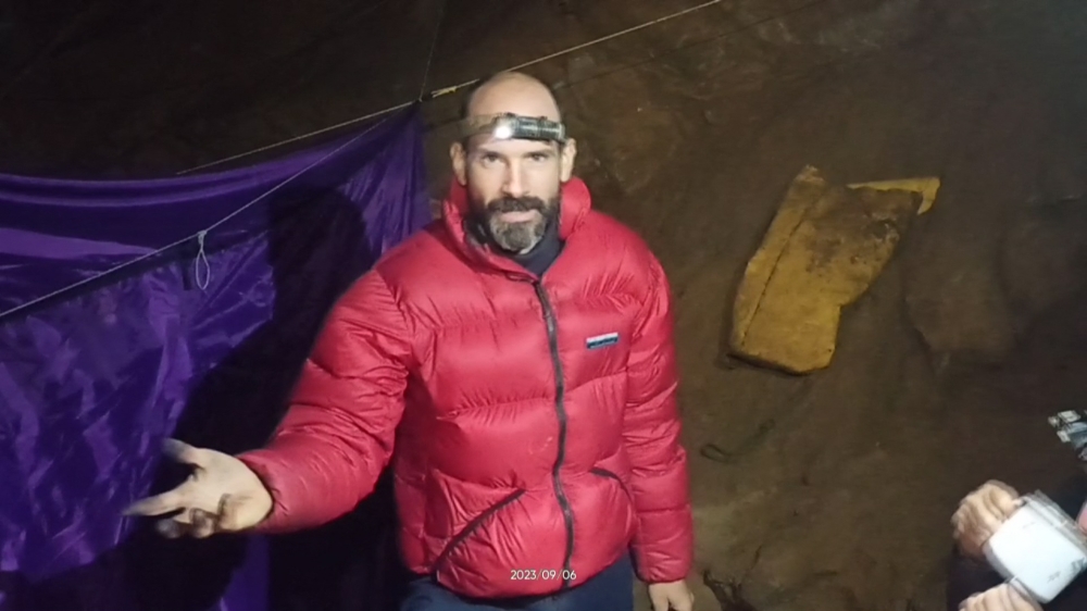 (Files) This video grab taken from footage released by The Turkish Direction of Communication on September 8, 2023, shows US caver Mark Dickey as he speaks to the camera while standing at a camp in the Morca Cave of the Taurus Mountains in southern Turkey. (Photo by Handout/ Turkish Direction of Communication / AFP) /