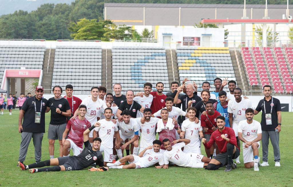 Qatar U-23 players and officials pose for a photo after defeating Kyrgyz Republic yesterday.