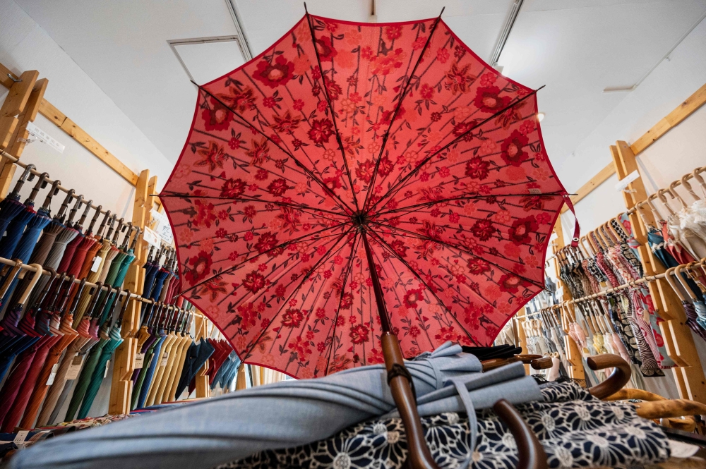 This photo taken on August 3, 2023 shows umbrellas on display at Komiya Shoten at the Higashi-Nihombashi area of Tokyo. (Photo by Richard A. Brooks / AFP) 