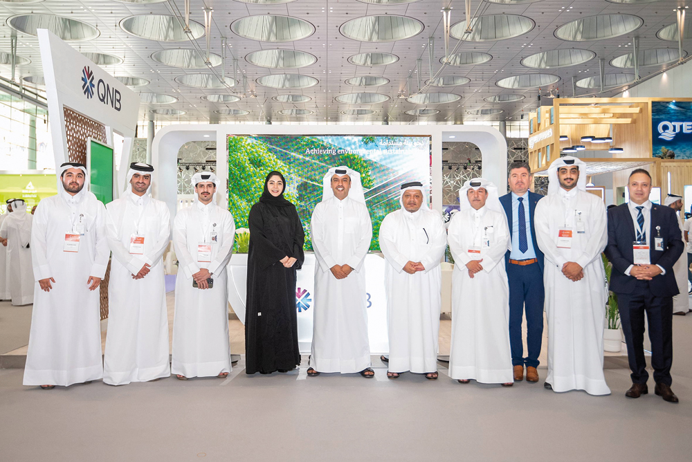 Officials pose for a group photo at the QNB pavilion.