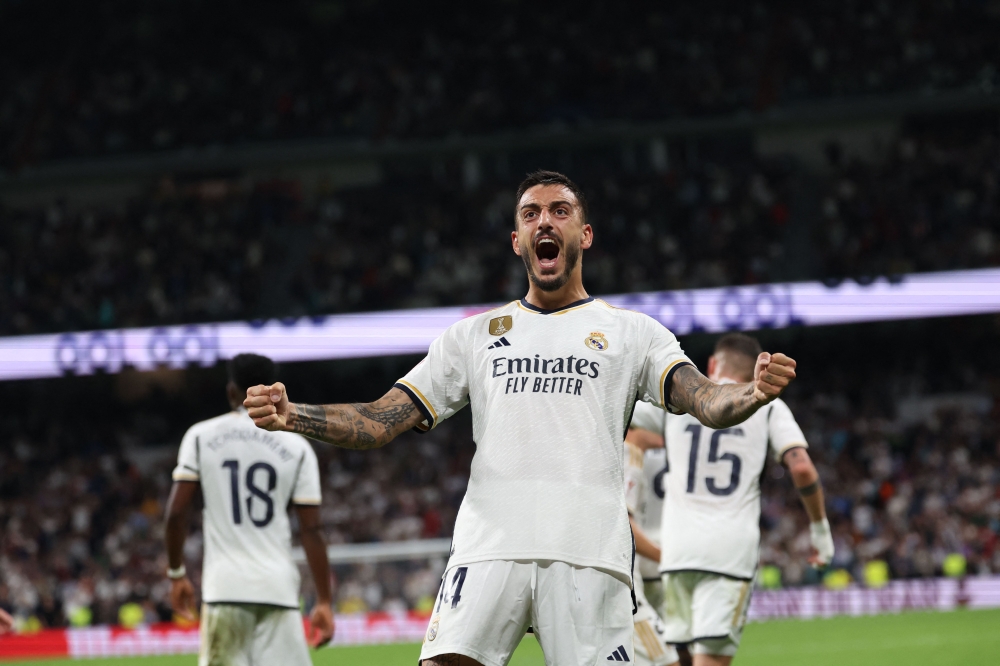 Real Madrid's Spanish forward #14 Joselu celebrates scoring his team's second goal during the Spanish Liga football match betweem Real Madrid and Real Sociedad at at the Santiago Bernabeu stadium in Madrid on September 17, 2023. (Photo by Pierre-Philippe MARCOU / AFP)