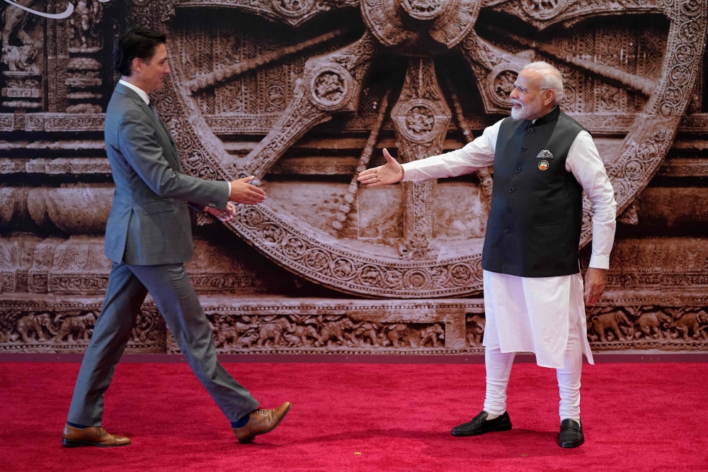 (Files) India's PM Narendra Modi (R) shakes hand with Canada's PM Justin Trudeau ahead of the G20 Leaders' Summit in New Delhi on September 9, 2023. (Photo by Evan Vucci / POOL / AFP)