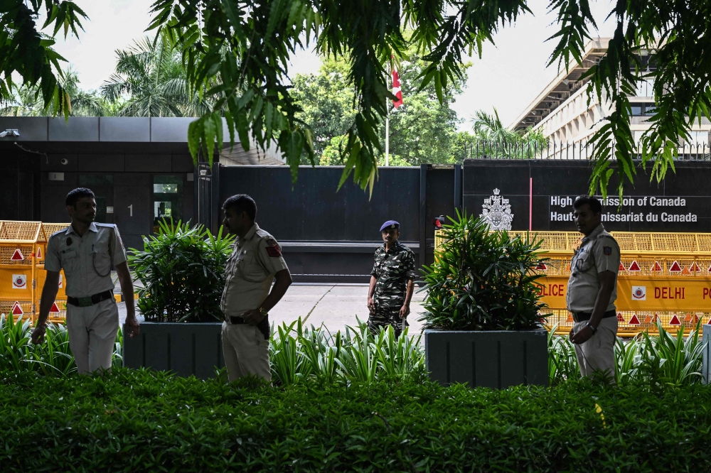 Security personnel stand guard in front of the High Commission of Canada in New Delhi on September 19, 2023. (Photo by Arun SANKAR / AFP)