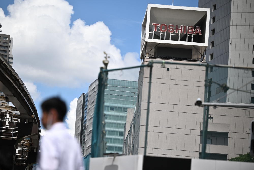 (Files) The logo of Japanese industrial group Toshiba is seen on top of a building at its headquarters in Tokyo on August 7, 2023. (Photo by Philip Fong / AFP)
 