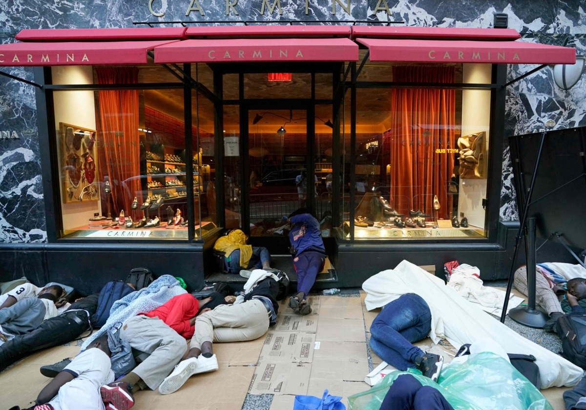 File Photo: Migrants sleep outside the Roosevelt Hotel as they wait for placement at the hotel in New York on Aug.1, 2023. AFP