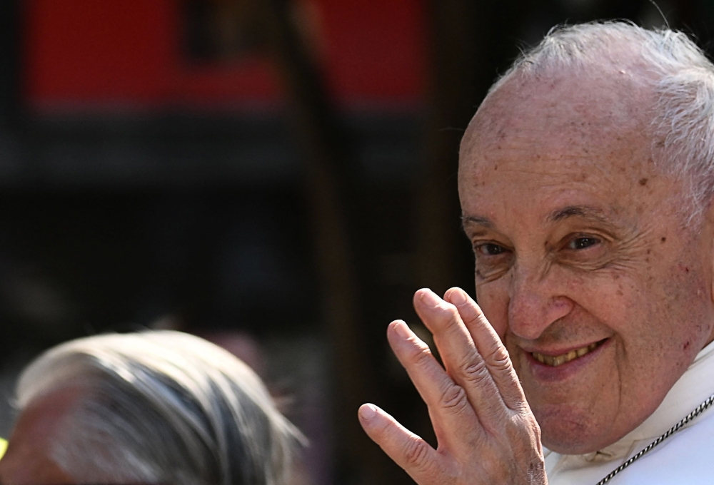 Pope Francis waves as rides in his popemobile past pilgrims and onlookers as he makes his way to celebrate mass at the Velodrome stadium, in the southern port city of Marseille on September 23, 2023. 
