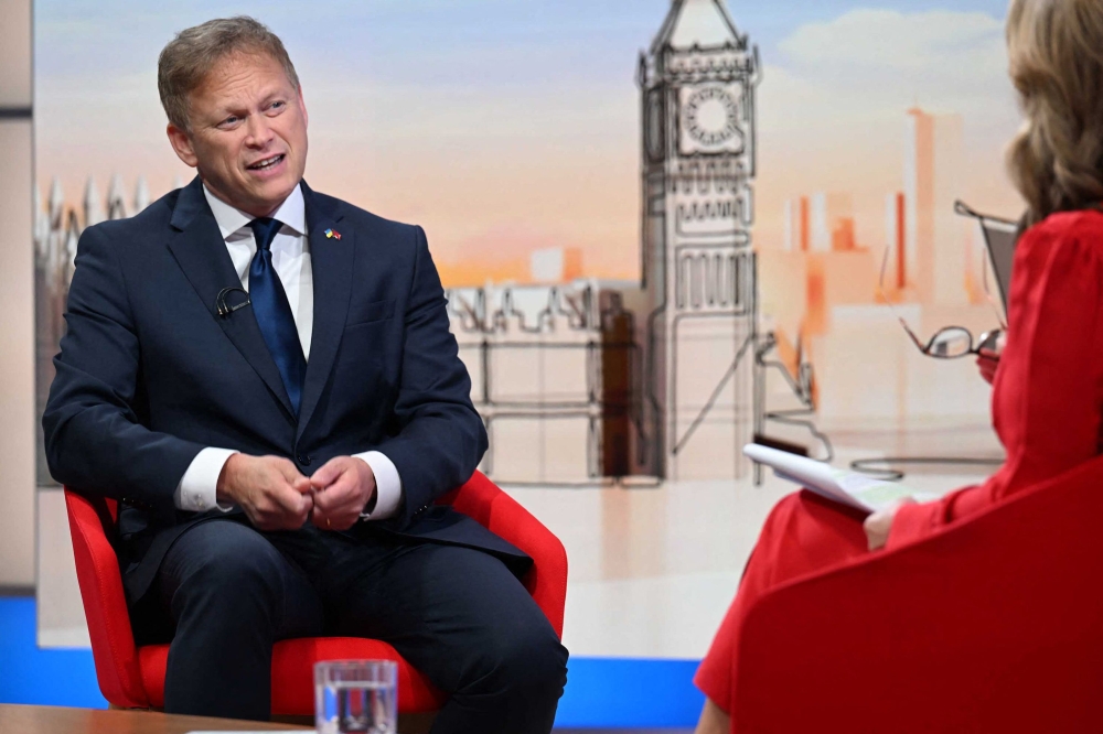 A handout picture released by the BBC, taken and received on September 24, 2023, shows Britain's Defence Secretary Grant Shapps appearing on the BBC's 'Sunday Morning' political television show with journalist Laura Kuenssberg. (Photo by Jeff Overs / BBC / AFP) 