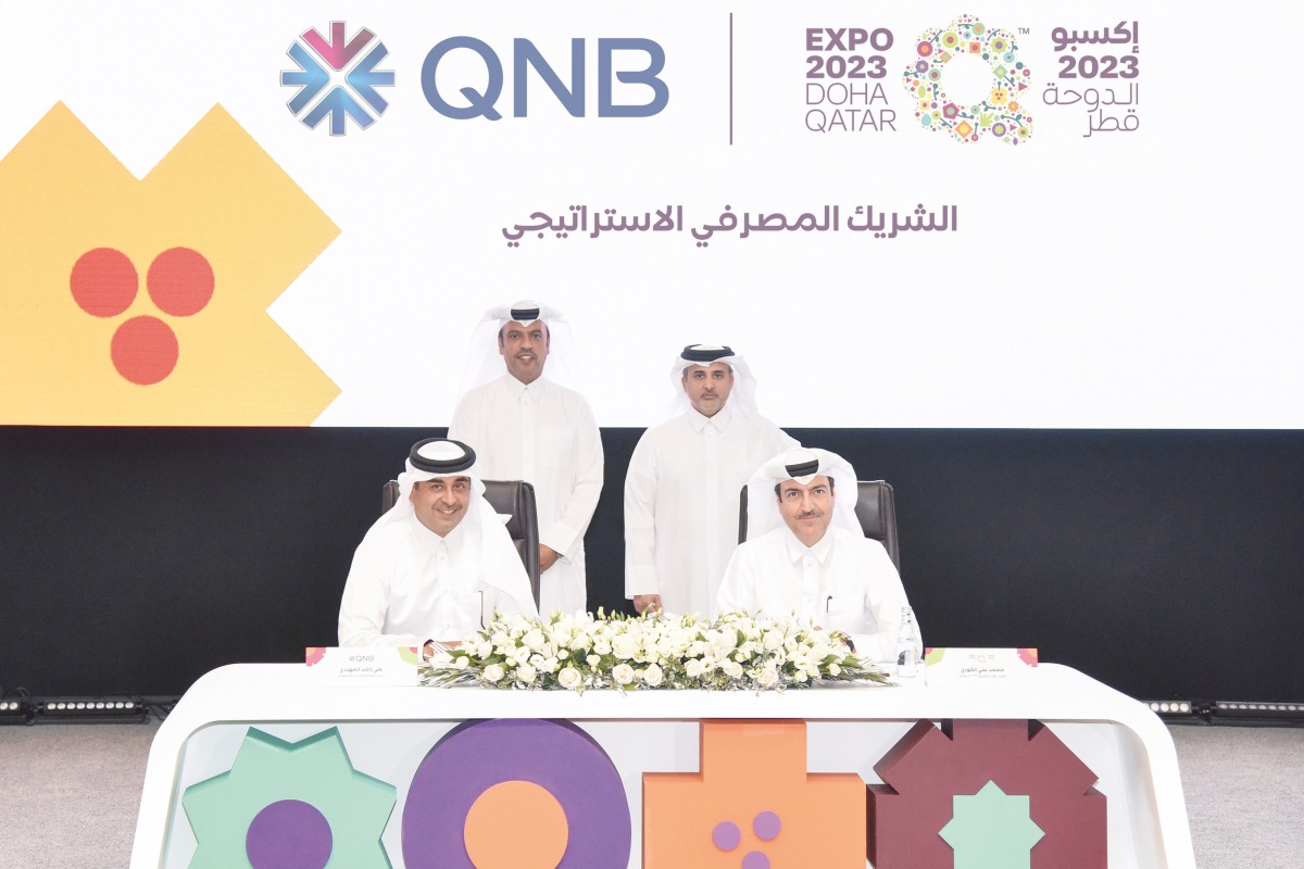 Minister of Municipality, H E Dr. Abdullah bin Abdulaziz bin Turki Al Subaie and QNB GCEO, Abdulla Mubarak Al Khalifa witnessing signing of agreement by QNB Group Chief Operating Officer, Ali Rashid Al Mohannadi; Expo 2023 Doha Qatar Secretary General, Mohamed Ali Al Khoury.