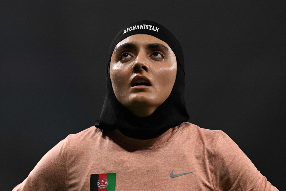 Afghanistan's Kimia Yousofi reacts after the women's 100m heats athletics event during the 2022 Asian Games in Hangzhou in China's eastern Zhejiang province on September 29, 2023. (Photo by William West / AFP)