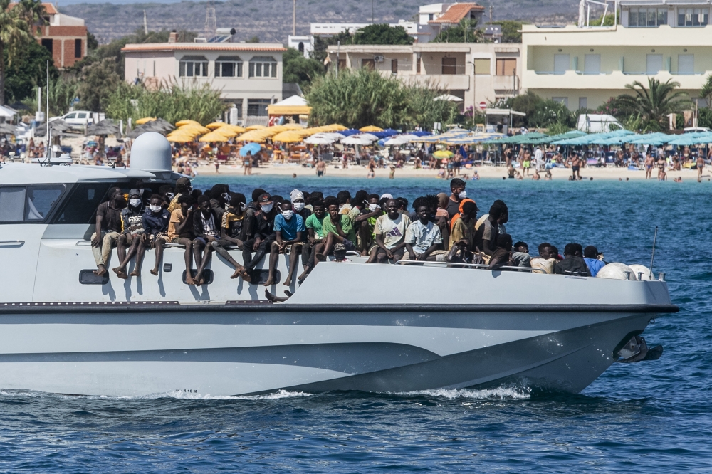 (Files) In this file picture migrants arrive on a Guardia di Finanza ship, in the harbour of Italian island of Lampedusa, on September 15, 2023. 
