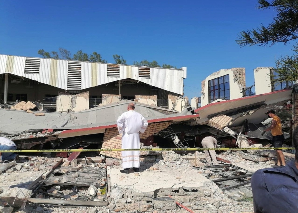 This handout picture released by the Tamaulipas Civil Protection shows a priest looking at the site where people were trapped after a church roof collapsed in Ciudad Madero, Tamaulipas State, Mexico, on October 1, 2023. Photo by Handout / Tamaulipas Civil Protection / AFP