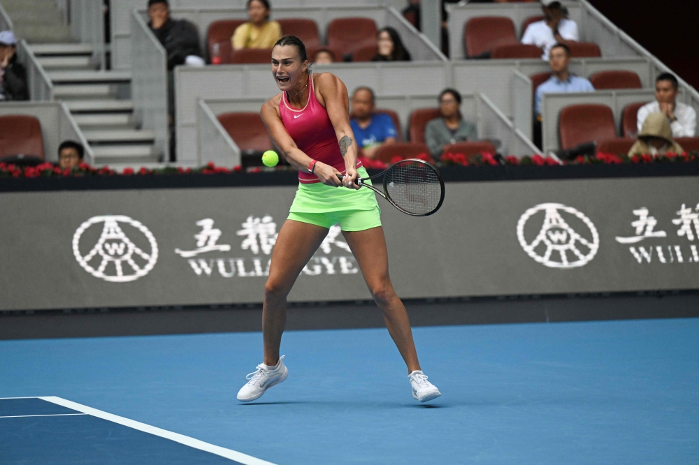 Belarus's Aryna Sabalenka hits a return to Britain's Katie Boulter during their women's singles match of the WTA China Open tennis tournament in Beijing on October 3, 2023. (Photo by Pedro Pardo / AFP)