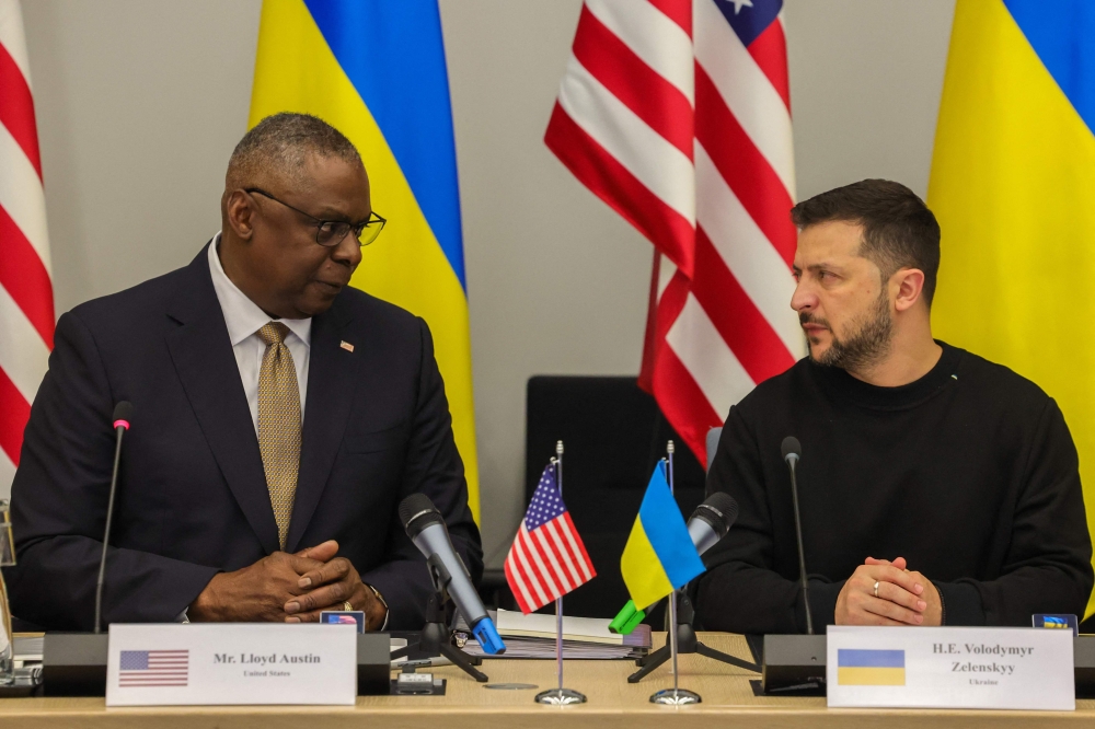 US Secretary Lloyd Austin (L) talks with President of Ukraine, Volodymyr Zelensky, during a Meeting of the Ukraine Defense Contact Group in Brussels, on October 11, 2023. (Photo by Olivier Matthys / Pool / AFP)

