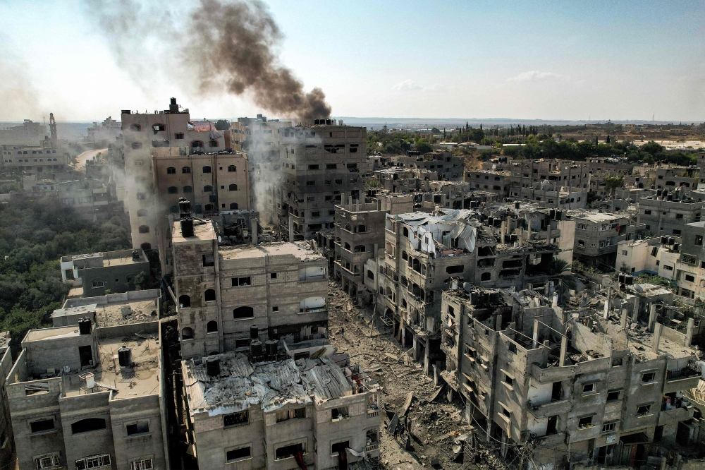 This picture taken on October 11, 2023, shows an aerial view of buildings destroyed by Israeli air strikes in the Jabalia camp for Palestinian refugees in Gaza City. (Photo by Yahya Hassouna / AFP)
