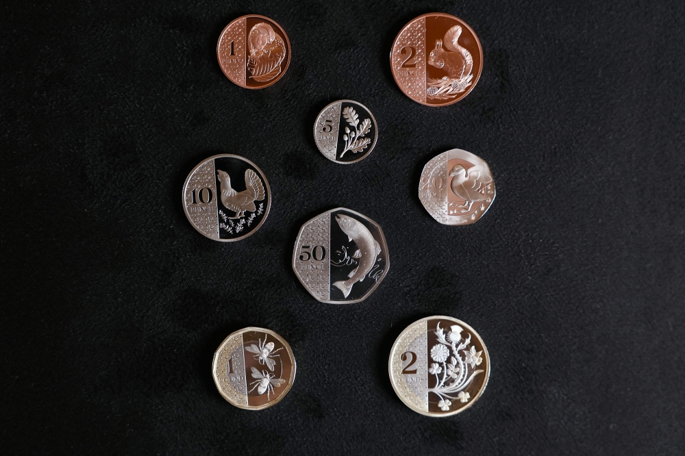 The full set of coins is seen displayed during a photocall to unveil eight new designs that are set to appear on UK coins, at the Royal Mint, in London on October 12, 2023. (Photo by Daniel Leal / AFP)