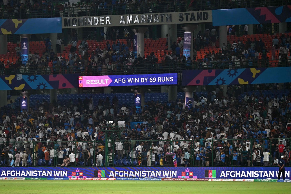 A screen shows Afghanistan's win against England at the end of the 2023 ICC Men's Cricket World Cup one-day international (ODI) match at the Arun Jaitley Stadium in New Delhi on October 15, 2023. (Photo by Money SHARMA / AFP)