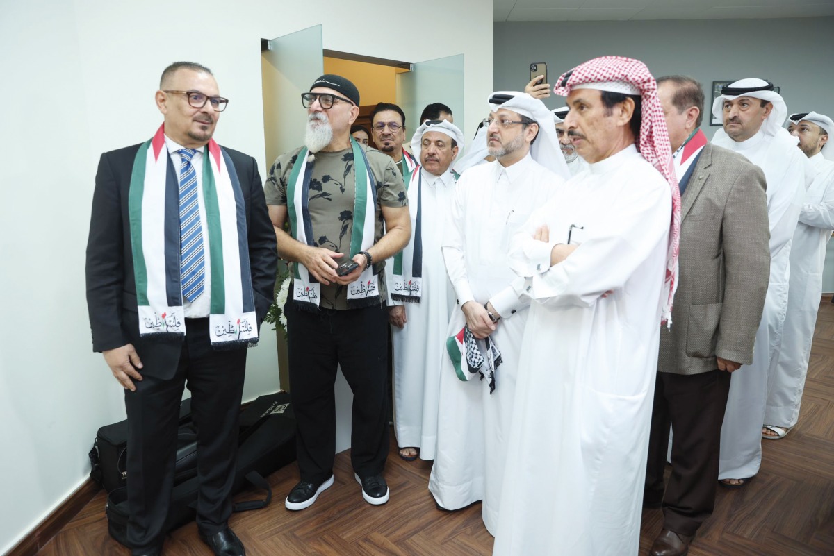 President of Qatar Press Center Saad Mohammed Al Rumaihi with photojournalist Karim Jaafar (first left) and other officials and guests touring the exhibition at the headquarters of the center yesterday.  Pic: Ahmed Barakat