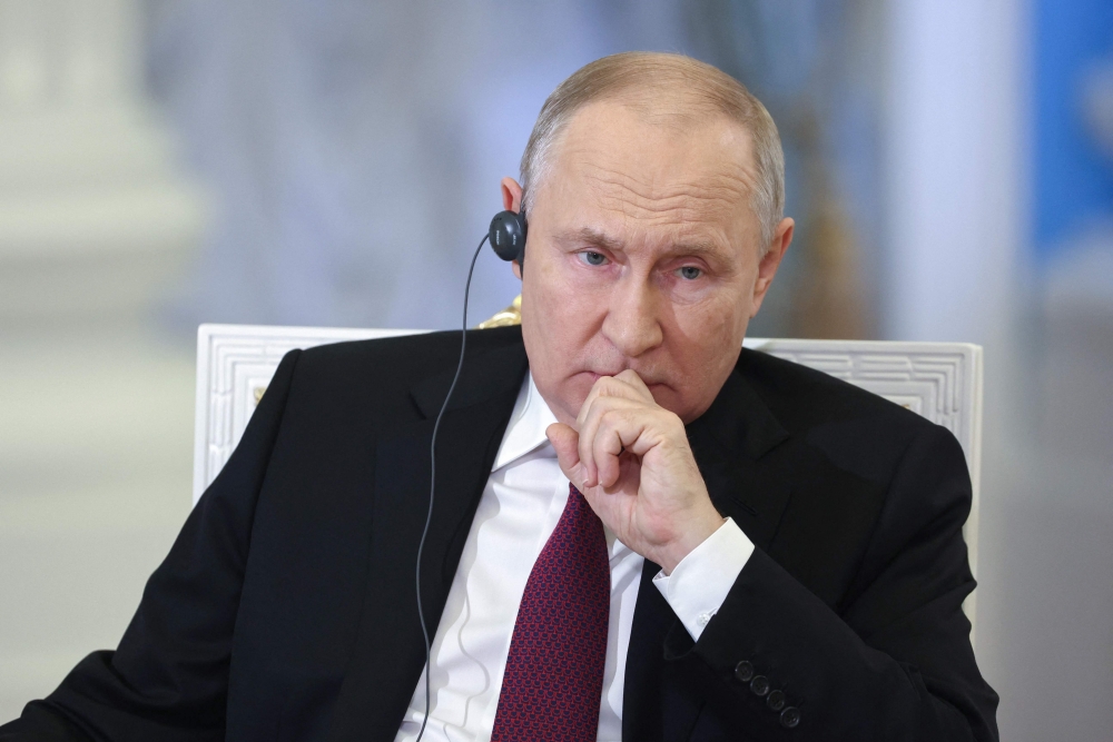 This pool photograph distributed by Russian state owned agency Sputnik shows Russia's President Vladimir Putin giving an interview at the Kremlin in Moscow on October 16, 2023. (Photo by Sergei Bobylyov / POOL / AFP)