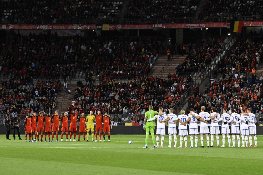 Belgium team (L) and Swedish team listen to the national anthems prior to the Euro 2024 qualifying football match between Belgium and Sweden at the King Baudouin Stadium in Brussels on October 16, 2023. (Photo by JOHN THYS / AFP)

