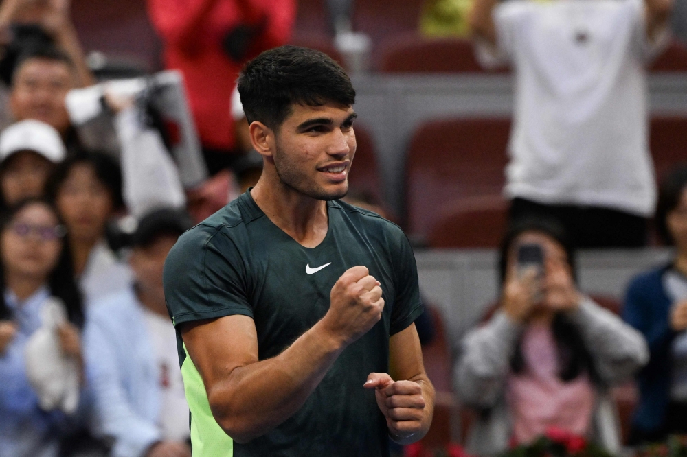 Spain's Carlos Alcaraz celebrates his victory against Italy's Lorenzo Musetti in their men's singles match during the China Open tennis tournament at the National Tennis Center in Beijing on October 1, 2023. (Photo by Pedro PARDO / AFP)

