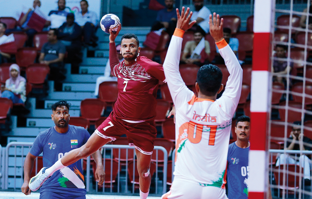 A Qatar player prepares to strike during match against India. 