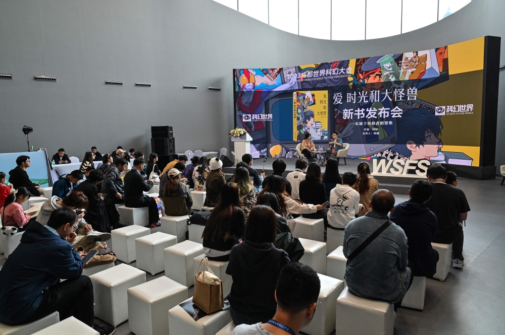 Visitors attend to the presentation of a book during the 2023 World Science Fiction Convention in Chengdu, in China's southwest Sichuan province on October 21, 2023. (Photo by Hector Retamal / AFP)