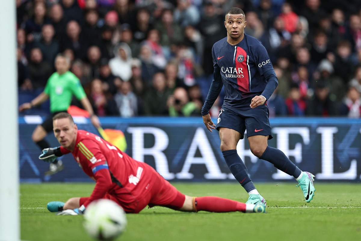 Paris Saint-Germain's French forward #07 Kylian Mbappe shoots the ball past Strasbourg's Belgian goalkeeper #01 Matz Sels during the French L1 football match between Paris Saint-Germain (PSG) and Strasbourg at the Parc des Princes stadium in Paris on October 21, 2023. (Photo by FRANCK FIFE / AFP)