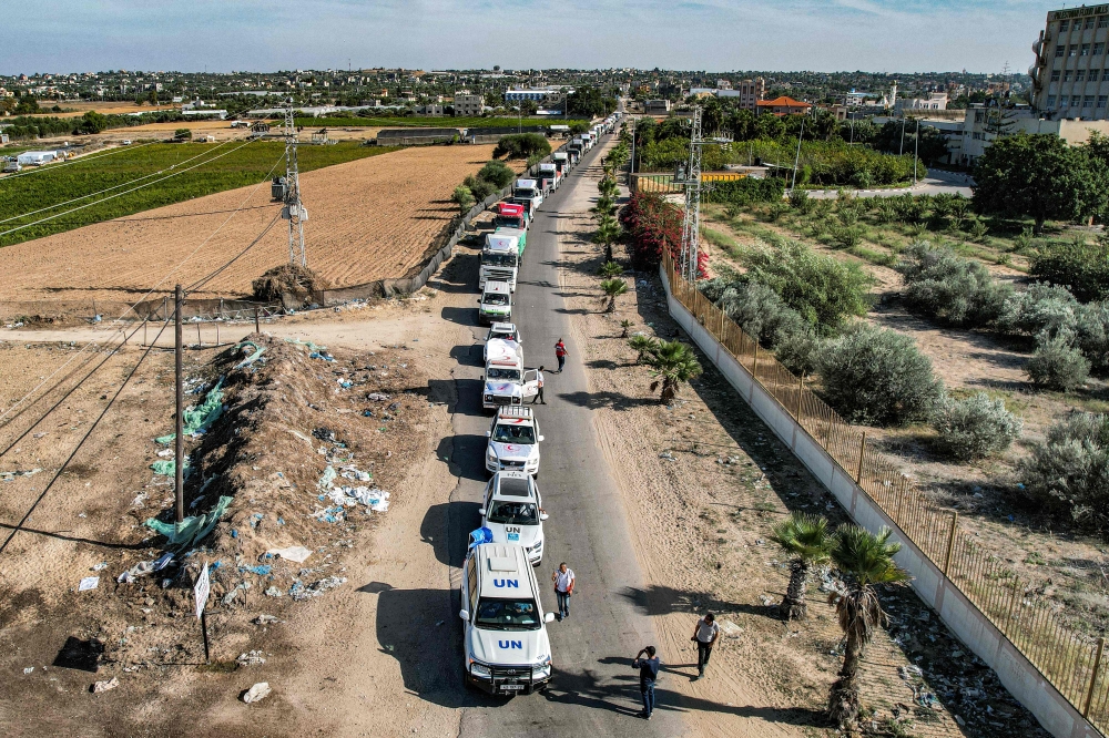 This aerial view shows humanitarian aid trucks arriving from Egypt after having crossed through the Rafah border crossing arriving at a storage facility in Khan Yunis in the southern Gaza Strip on October 21, 2023. Photo by Belal Al SABBAGH / AFP