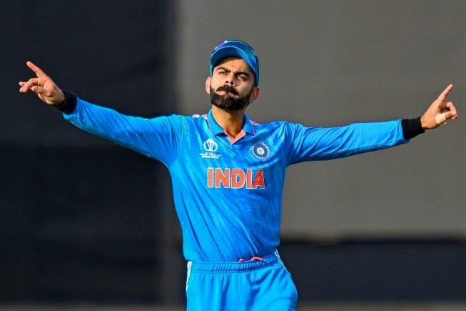 India's Virat Kohli dances to music during the 2023 ICC Men's Cricket World Cup one-day international (ODI) match between India and New Zealand at the Himachal Pradesh Cricket Association Stadium in Dharamsala on October 22, 2023. (Photo by Money Sharma / AFP)