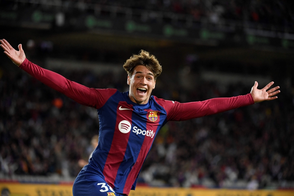 Barcelona's Spanish forward #38 Marc Guiu celebrates after scoring his team's first goal during the Spanish league football match between FC Barcelona and Athletic Club Bilbao at the Estadi Olimpic Lluis Companys in Barcelona on October 22, 2023. (Photo by Josep Lago / AFP)
 