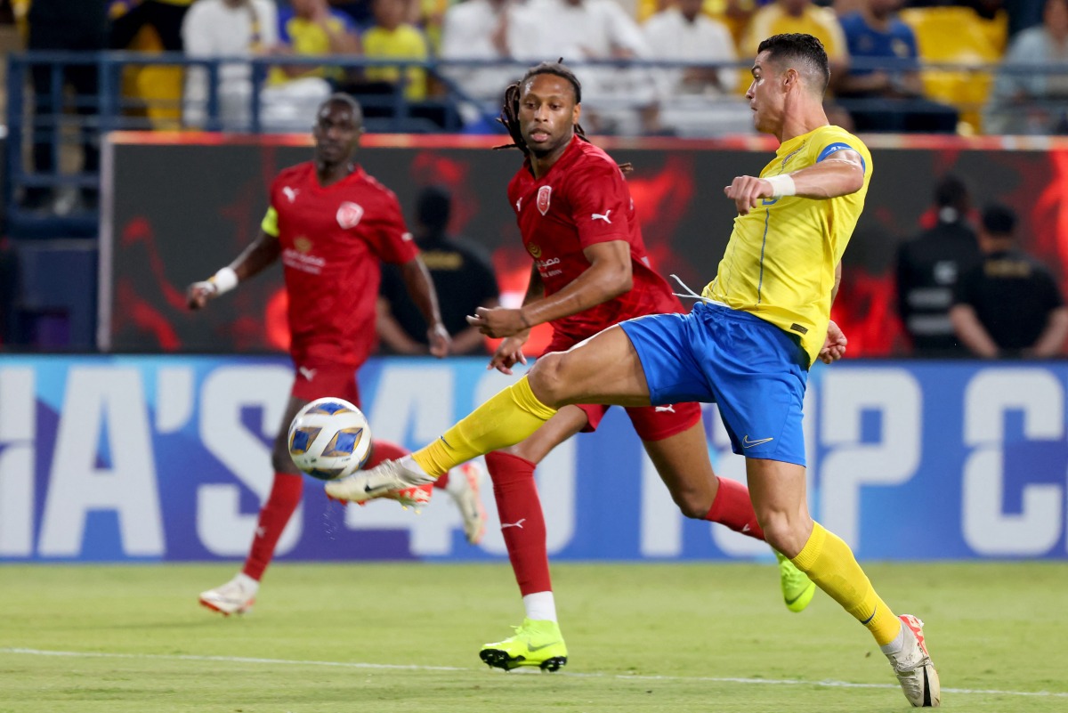Al Duhail’s Ruben Semedo (centre) and Al Nassr’s Cristiano Ronaldo in action. AFP