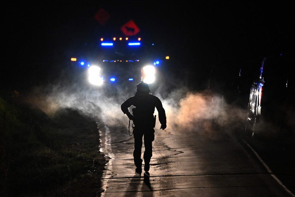 Law enforcement are seen outside the home of suspect Robert Card's father and brother in Bowdoin, Maine on October 26, 2023, in the aftermath of a mass shootings in Lewiston, Maine. Photo by ANGELA WEISS / AFP
