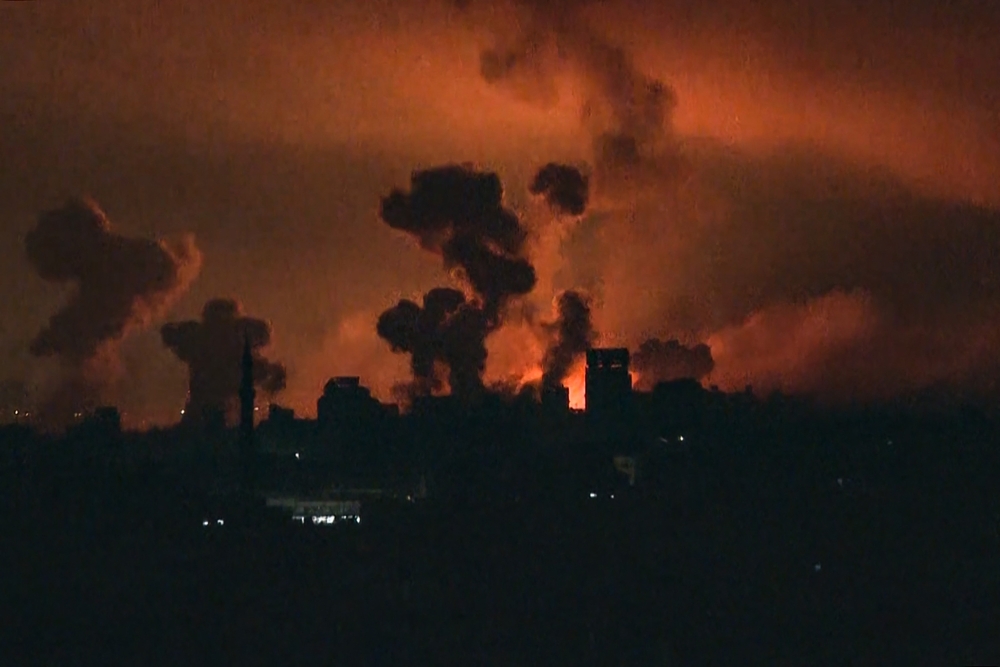 This image grab from an AFP TV footage shows fire and smoke rising above Gaza City during an Israeli strike on October 27, 2023, as battles between Israel and the Palestinian Hamas movement continue. (Photo by AFP)
