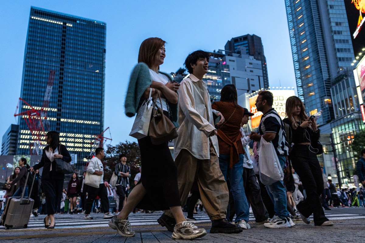 Pedestrians at a busy intersections of Tokyo on October 27, 2023. (Photo by Philip Fong / AFP)